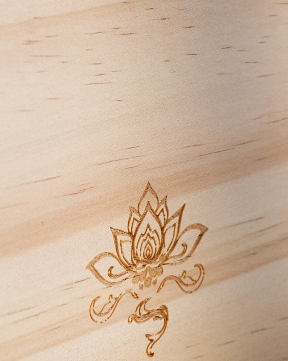 A lotus engraved in natural pine