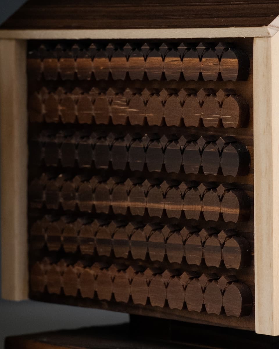 Rows of small wooden niches on the wall of the House